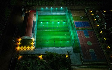 Night-time box cricket and activities at USM Infra Go Ranch Resort Sandalwood Farm