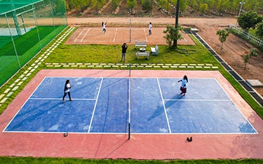 outdoor pickleball experience at USM Infra Go Ranch |Invest in a plot at USM Infra Go Ranch Resort and enjoy exclusive benefits, including resort membership and sandalwood profits