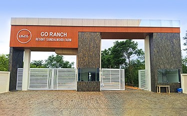 Discover the grand entrance of USM Infra Go Ranch Sandalwood Farm, a premium gated community near Hyderabad, offering luxurious plots surrounded by nature's beauty.